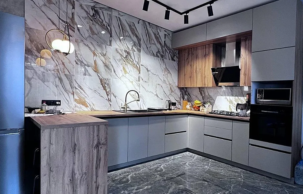 Modern kitchen with big gold marble tile and white cabinets
