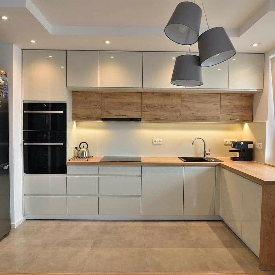 Compact kitchen with white face cabinets and wooden countertop