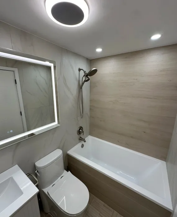 small bathroom with marbel and wood tile, buthtub